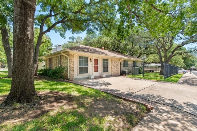 12701 Poquoson Dr, Austin, TX 78727 - ranch-style home with a chimney, brick siding, a gate, and central AC