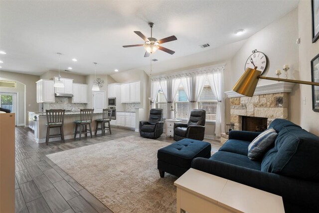 213 Russet Trl, Georgetown, TX 78628 - living area featuring ceiling fan, a fireplace, wood finished floors, recessed lighting, and baseboards