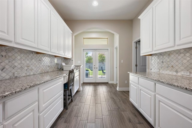 213 Russet Trl, Georgetown, TX 78628 - kitchen featuring arched walkways, french doors, white cabinets, tasteful backsplash, and recessed lighting