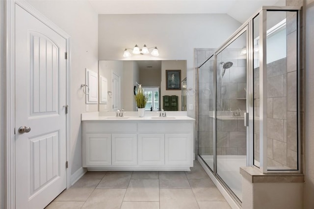 213 Russet Trl, Georgetown, TX 78628 - full bathroom featuring double vanity, a shower stall, tile patterned flooring, lofted ceiling, and baseboards