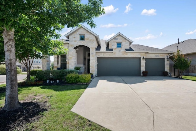 213 Russet Trl, Georgetown, TX 78628 - french country style house with stone siding, driveway, an attached garage, and a front lawn