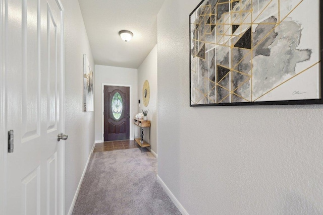 1207 Tricia Cv, Hutto, TX 78634 - doorway featuring carpet floors, baseboards, and a textured wall