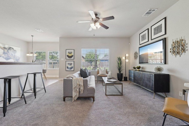 1207 Tricia Cv, Hutto, TX 78634 - living area featuring carpet flooring, ceiling fan, and a chandelier