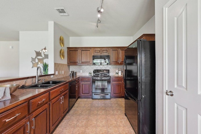1207 Tricia Cv, Hutto, TX 78634 - kitchen with black appliances, a sink, decorative backsplash, dark countertops, and brown cabinetry