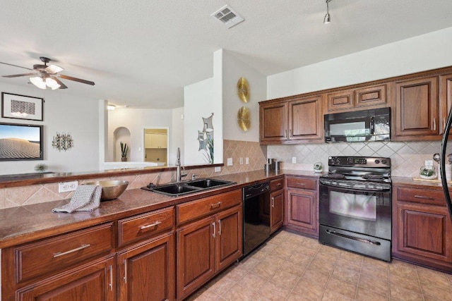 1207 Tricia Cv, Hutto, TX 78634 - kitchen with black appliances, a sink, dark countertops, tasteful backsplash, and ceiling fan