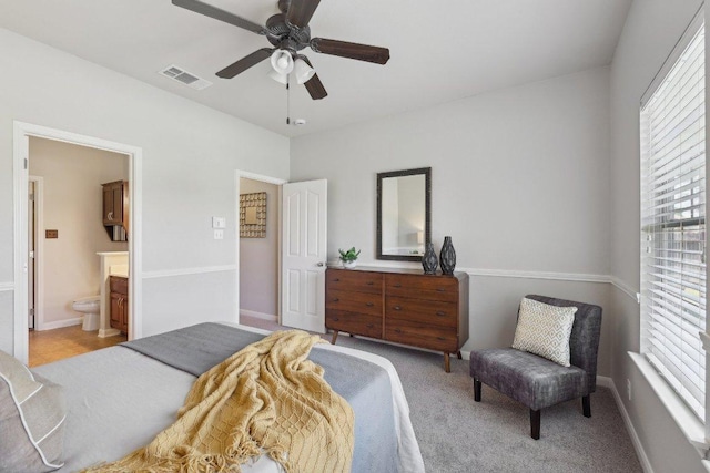 1207 Tricia Cv, Hutto, TX 78634 - bedroom with multiple windows, connected bathroom, a ceiling fan, and baseboards