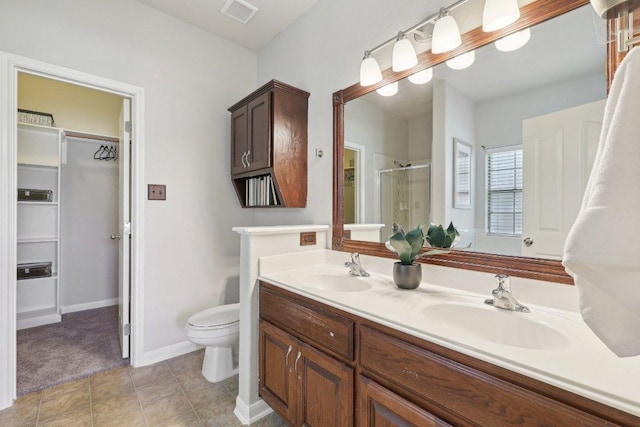 1207 Tricia Cv, Hutto, TX 78634 - full bathroom with a stall shower, a spacious closet, double vanity, and toilet
