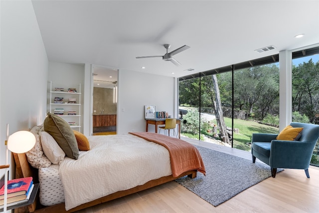 300 Summer Hills Dr, Wimberley, TX 78676 - bedroom with wood finished floors, multiple windows, a wall of windows, a ceiling fan, and recessed lighting