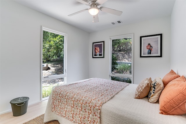 300 Summer Hills Dr, Wimberley, TX 78676 - bedroom featuring multiple windows, wood finished floors, and a ceiling fan