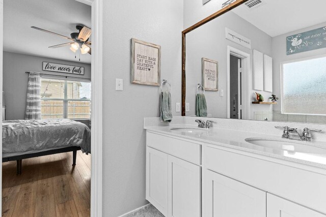 421 Perfect World Loop, Jarrell, TX 76537 - ensuite bathroom with double vanity, ceiling fan, and wood finished floors