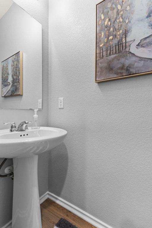 421 Perfect World Loop, Jarrell, TX 76537 - bathroom featuring wood finished floors and baseboards