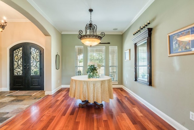 421 Huck Finn Trl, Dripping Springs, TX 78620 - foyer entrance with arched walkways, wood finished floors, ornamental molding, and baseboards