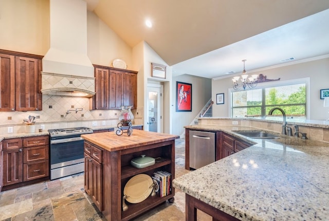 421 Huck Finn Trl, Dripping Springs, TX 78620 - kitchen featuring stainless steel appliances, a sink, custom exhaust hood, wooden counters, and a chandelier