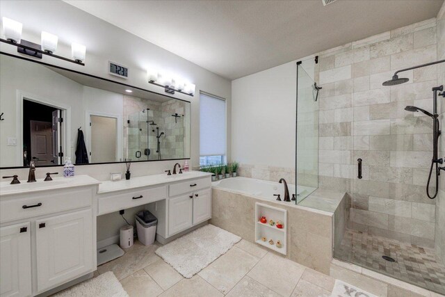 9508 Bully Hill Cv, Austin, TX 78759 - full bath with a stall shower, a bath, double vanity, and tile patterned flooring