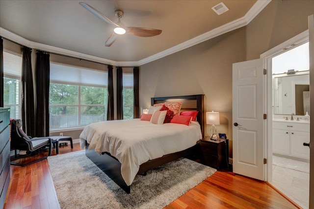 9508 Bully Hill Cv, Austin, TX 78759 - bedroom featuring ornamental molding, wood finished floors, ensuite bath, and ceiling fan