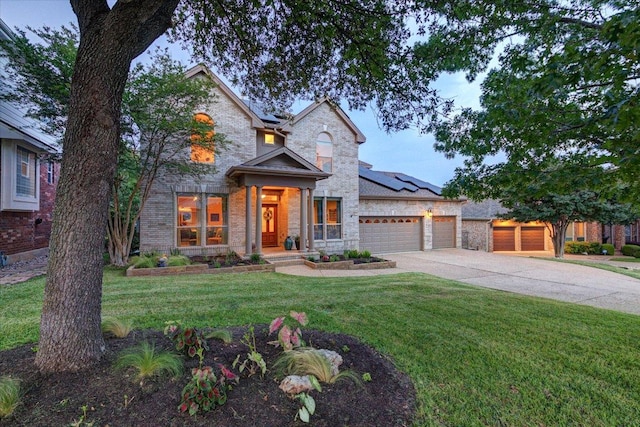 9508 Bully Hill Cv, Austin, TX 78759 - view of front of property with driveway, solar panels, a garage, a front lawn, and brick siding