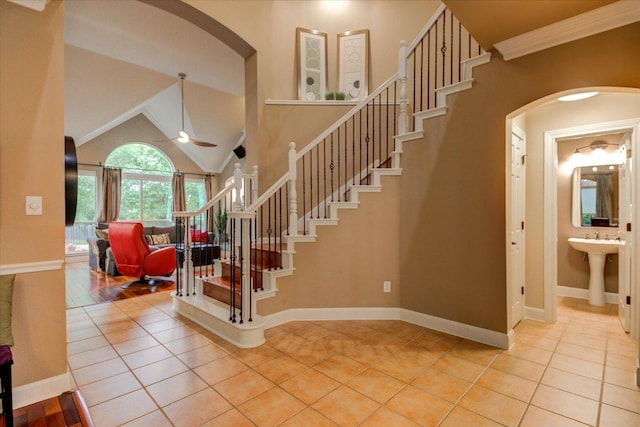 9508 Bully Hill Cv, Austin, TX 78759 - stairs with arched walkways, a ceiling fan, tile patterned flooring, baseboards, and high vaulted ceiling