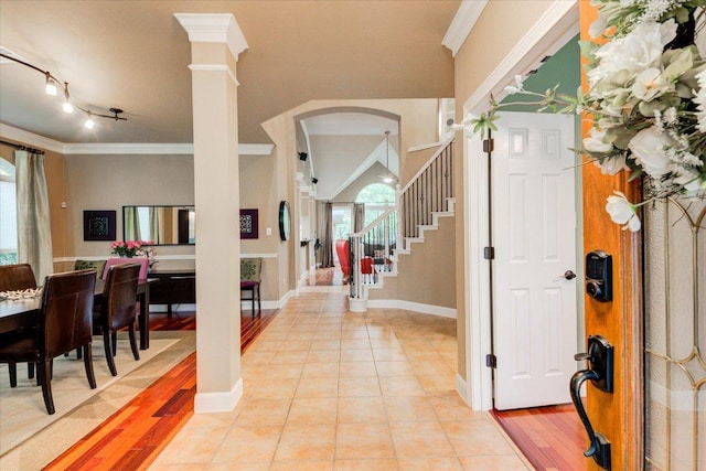 9508 Bully Hill Cv, Austin, TX 78759 - foyer with crown molding, arched walkways, baseboards, stairs, and light wood-style flooring