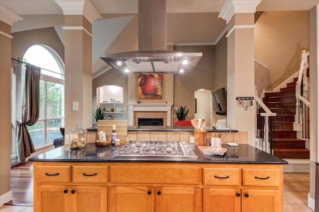 9508 Bully Hill Cv, Austin, TX 78759 - kitchen featuring island exhaust hood, stainless steel gas cooktop, open floor plan, dark stone countertops, and crown molding