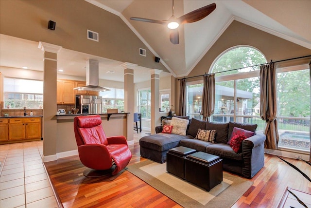 9508 Bully Hill Cv, Austin, TX 78759 - living room featuring decorative columns, light wood finished floors, healthy amount of natural light, a ceiling fan, and high vaulted ceiling