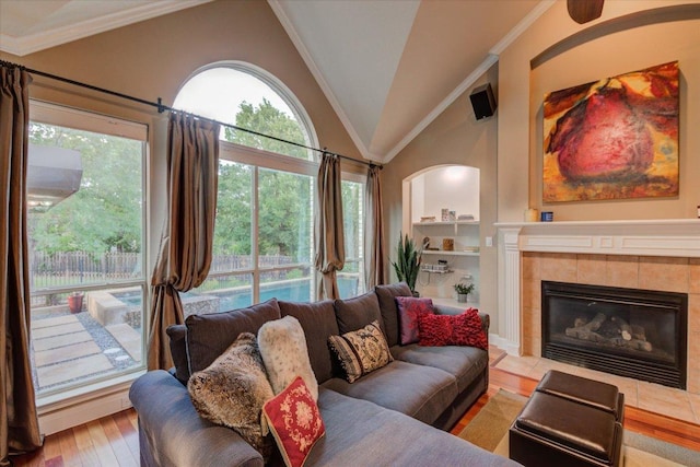 9508 Bully Hill Cv, Austin, TX 78759 - living area with vaulted ceiling, a fireplace, wood finished floors, and ornamental molding