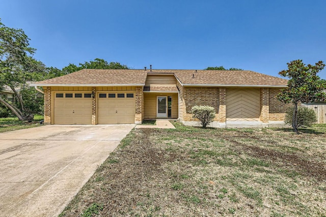11306 Thorny Brook Trl, Austin, TX 78750 - view of front of home featuring an attached garage, brick siding, and driveway