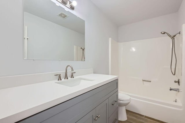 11306 Thorny Brook Trl, Austin, TX 78750 - bathroom featuring vanity, toilet, shower / washtub combination, and wood finished floors