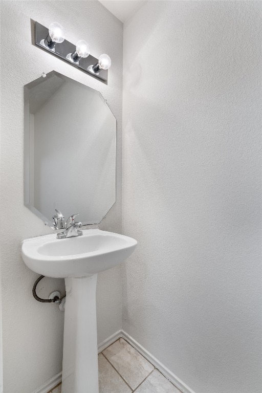 7432 Cayenne Ln, Austin, TX 78741 - bathroom featuring tile patterned floors, a sink, and baseboards