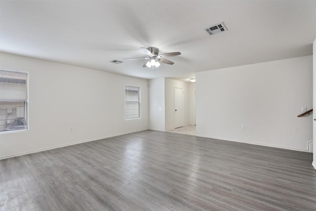 7432 Cayenne Ln, Austin, TX 78741 - unfurnished room featuring ceiling fan, wood finished floors, and baseboards