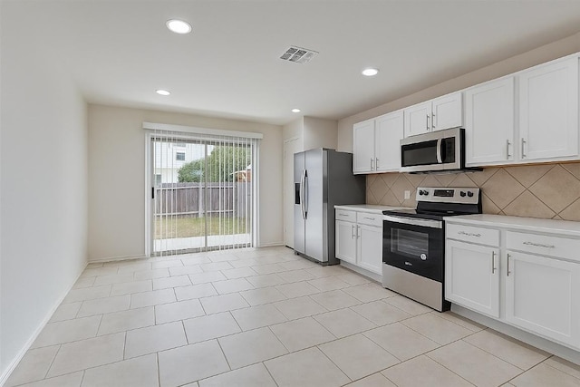 7432 Cayenne Ln, Austin, TX 78741 - kitchen with stainless steel appliances, tasteful backsplash, light countertops, white cabinets, and recessed lighting