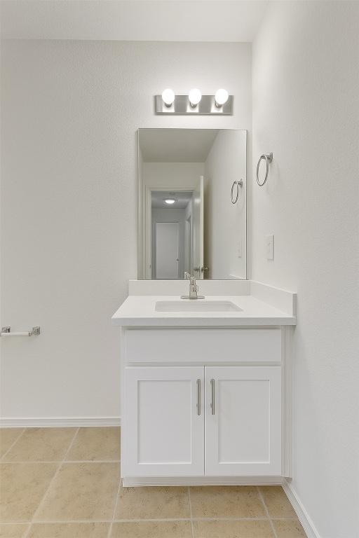 7432 Cayenne Ln, Austin, TX 78741 - bathroom with vanity, baseboards, and tile patterned flooring