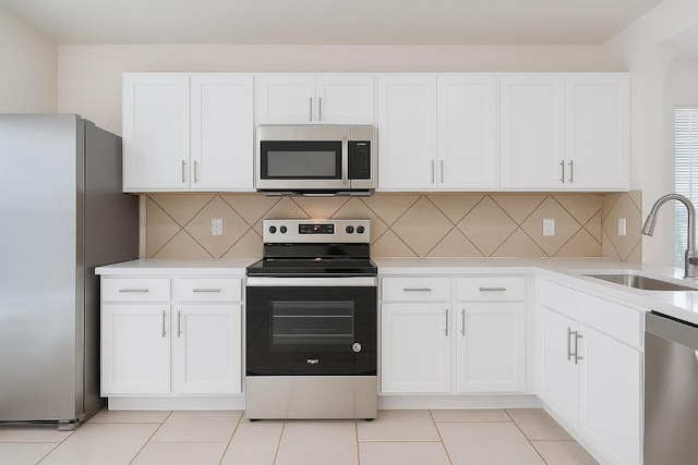 7432 Cayenne Ln, Austin, TX 78741 - kitchen with stainless steel appliances, a sink, light countertops, and white cabinetry