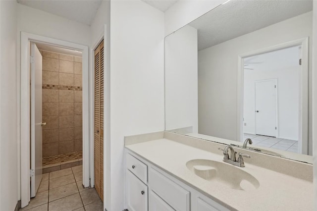 4307 S 1st St Unit 104, Austin, TX 78745 - full bath with vanity, a tile shower, tile patterned floors, and a closet