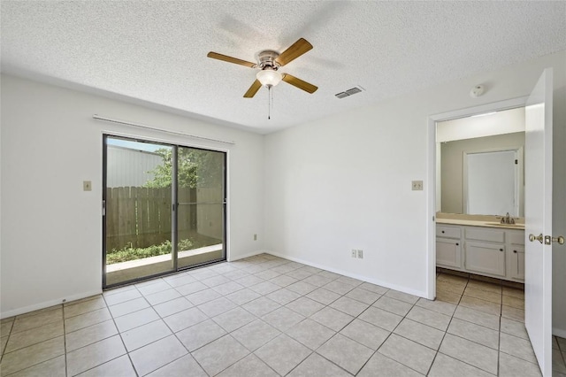 4307 S 1st St Unit 104, Austin, TX 78745 - unfurnished room with ceiling fan, a textured ceiling, and light tile patterned floors