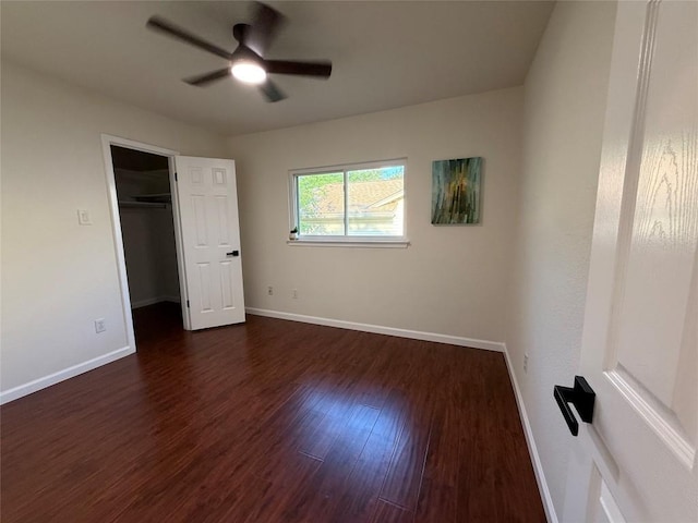 12225 Mosley Ln, Austin, TX 78727 - unfurnished bedroom featuring dark wood-style floors, baseboards, a walk in closet, and a ceiling fan