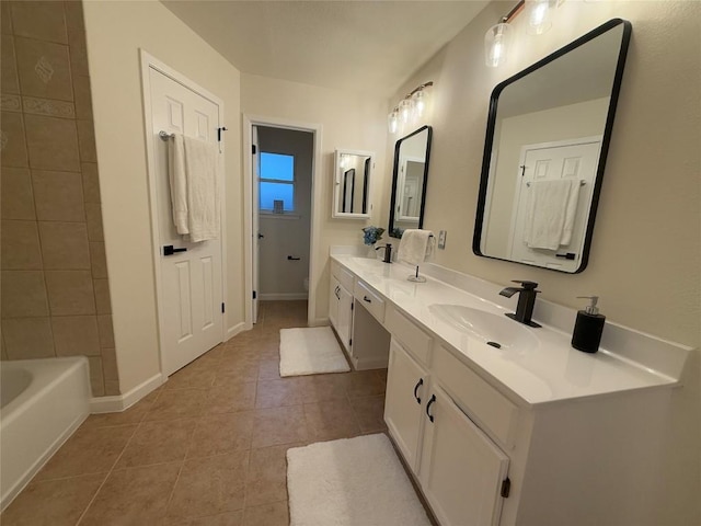 12225 Mosley Ln, Austin, TX 78727 - bathroom with tile patterned flooring, double vanity, and baseboards