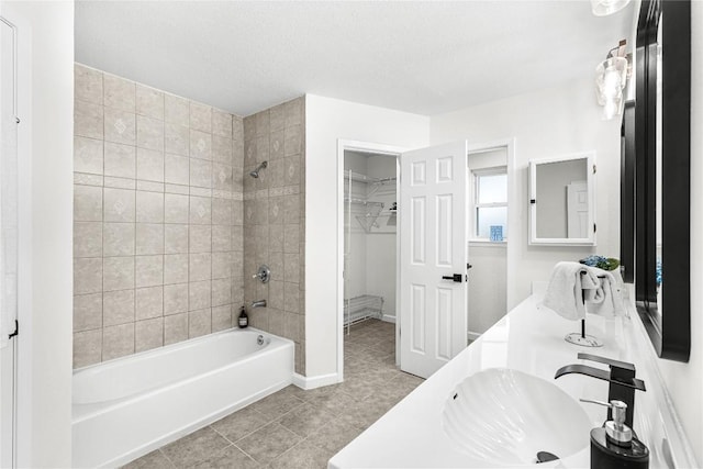 12225 Mosley Ln, Austin, TX 78727 - bathroom featuring bathtub / shower combination, tile patterned floors, double vanity, and a walk in closet
