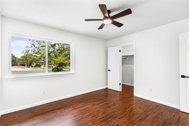 12225 Mosley Ln, Austin, TX 78727 - unfurnished bedroom featuring wood finished floors, a walk in closet, ceiling fan, and a closet