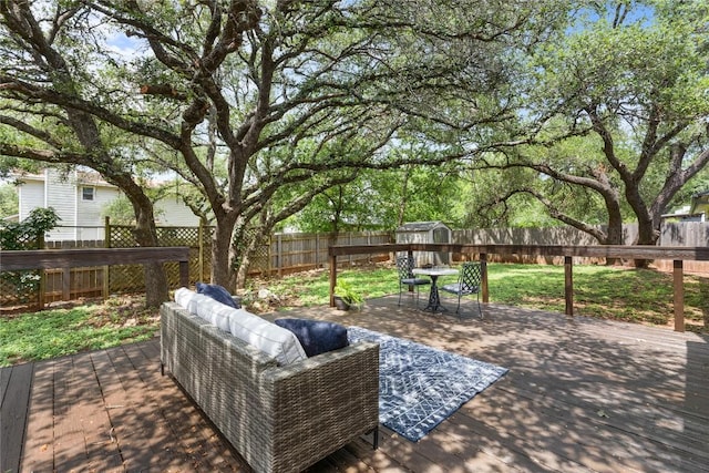 12225 Mosley Ln, Austin, TX 78727 - deck featuring a fenced backyard, a storage unit, and an outdoor hangout area