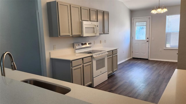 12805 Sky Harbor Dr, Del Valle, TX 78617 - kitchen featuring white appliances, a sink, gray cabinetry, dark wood-style flooring, and light countertops