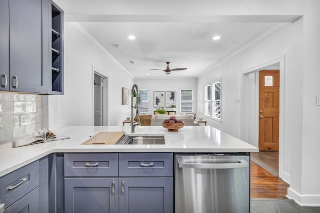 803 Josephine St, Austin, TX 78704 - kitchen with stainless steel dishwasher, a peninsula, ornamental molding, light countertops, and ceiling fan