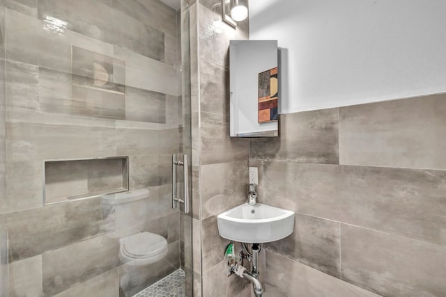 803 Josephine St, Austin, TX 78704 - full bathroom with a stall shower, tile walls, a sink, and toilet