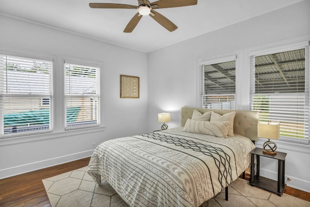 803 Josephine St, Austin, TX 78704 - bedroom featuring multiple windows, baseboards, wood finished floors, and ceiling fan