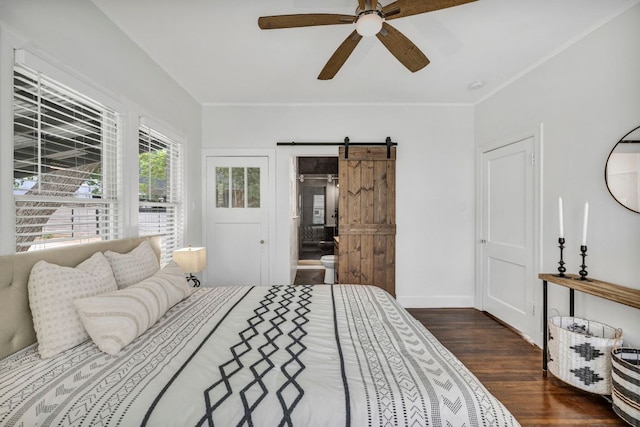 803 Josephine St, Austin, TX 78704 - bedroom with a barn door, wood finished floors, baseboards, crown molding, and ensuite bathroom