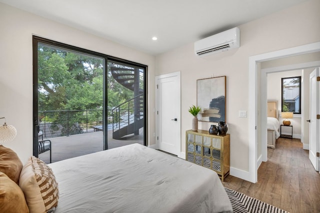 803 Josephine St, Austin, TX 78704 - bedroom with a wall mounted air conditioner, access to exterior, wood finished floors, and recessed lighting