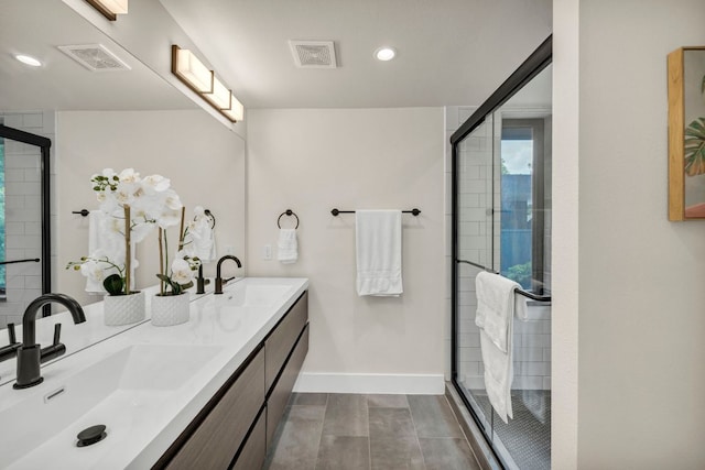 803 Josephine St, Austin, TX 78704 - bathroom with baseboards, double vanity, a stall shower, and recessed lighting