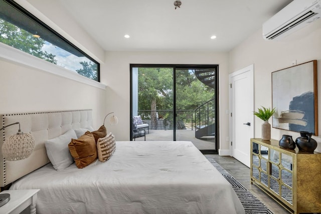 803 Josephine St, Austin, TX 78704 - bedroom featuring an AC wall unit, access to exterior, multiple windows, wood finished floors, and recessed lighting