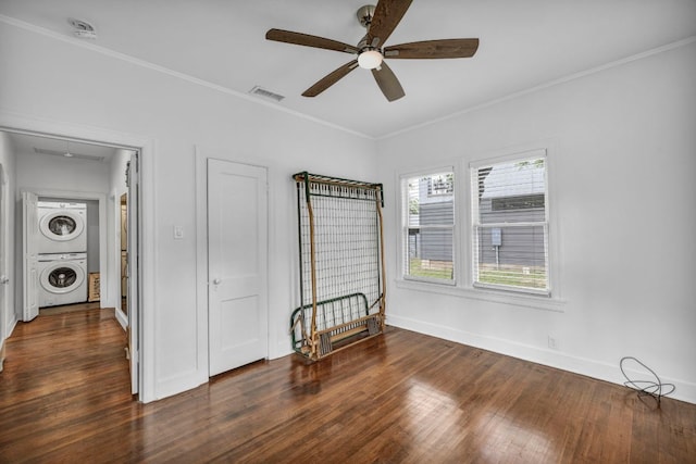 803 Josephine St, Austin, TX 78704 - unfurnished bedroom with stacked washer and clothes dryer, wood finished floors, ornamental molding, baseboards, and attic access