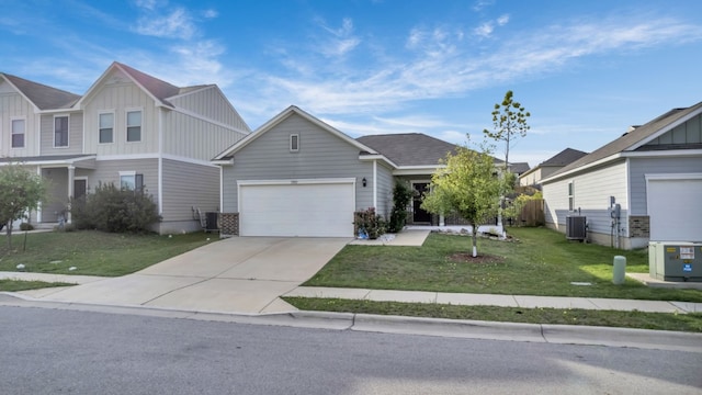 13013 Titanium St, Austin, TX 78754 - view of front of house with board and batten siding, central AC unit, driveway, and a front yard