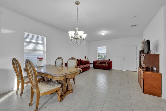 13013 Titanium St, Austin, TX 78754 - dining space featuring a chandelier and light tile patterned flooring